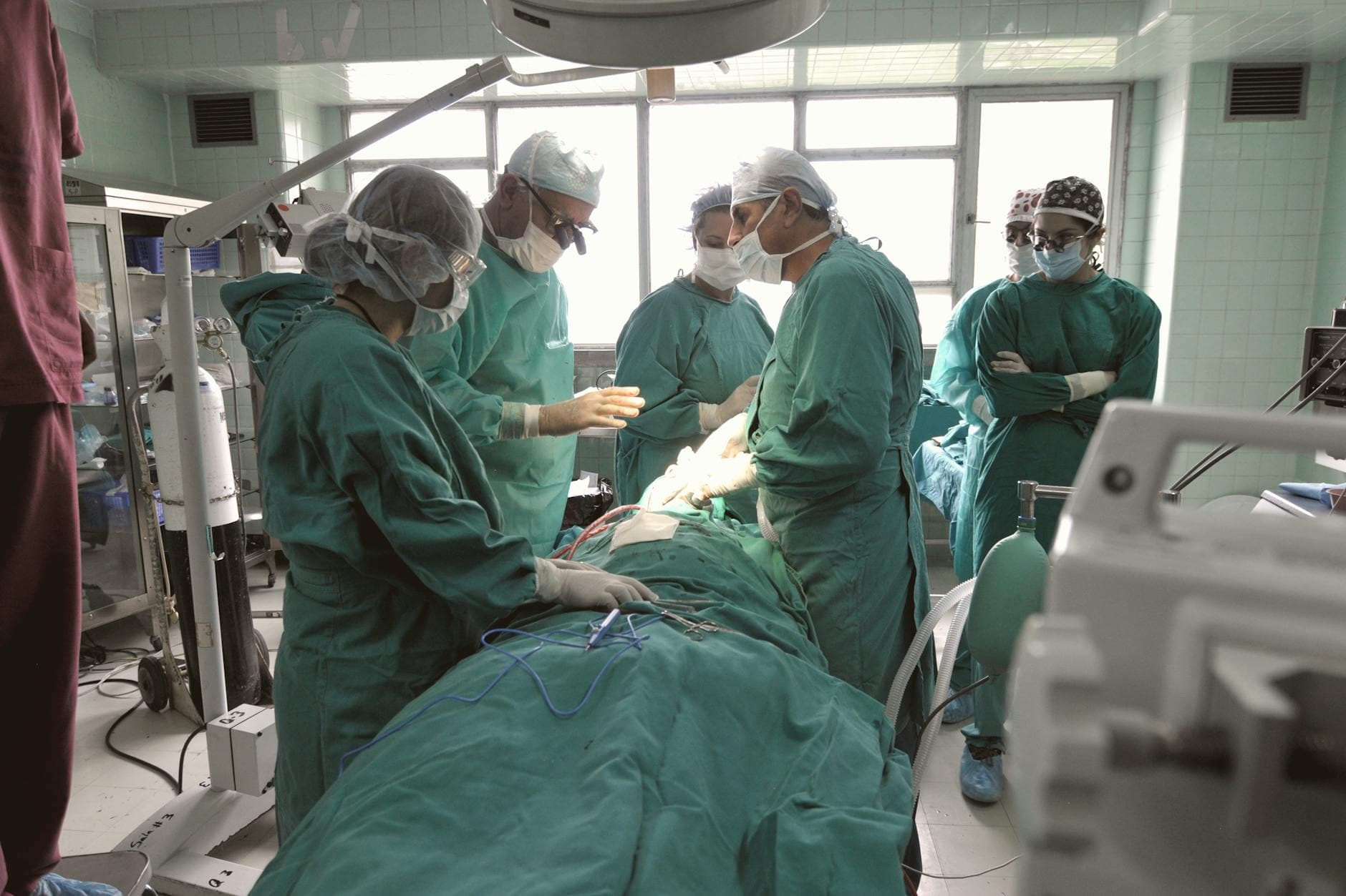 A team of surgeons in an operating room focused on a critical procedure.