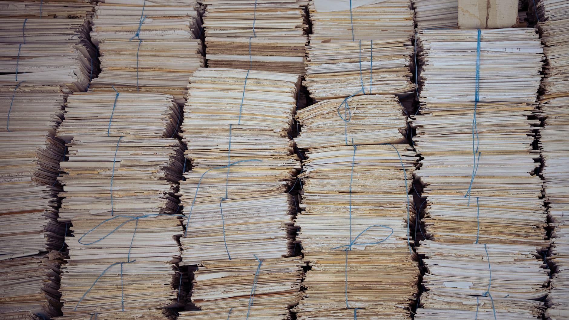 High stacks of organized, bound paper bundles create a structured and neat appearance.