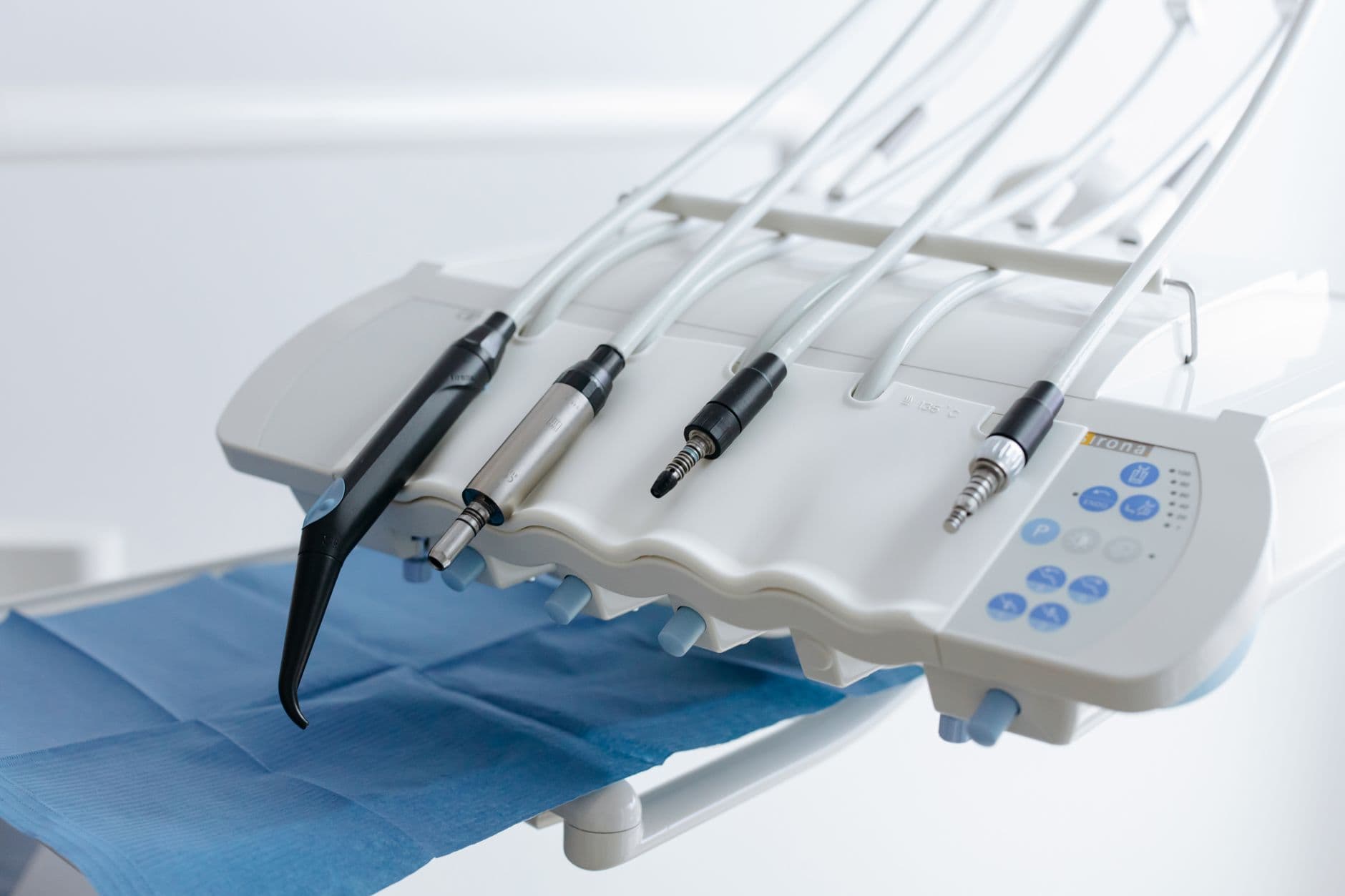 Close-up of dental equipment with handpieces, showcasing modern dental care tools in a clinic.